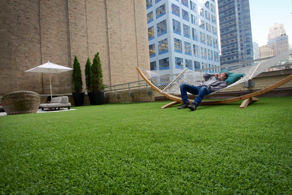 Apartment common area with an artificial grass lawn
