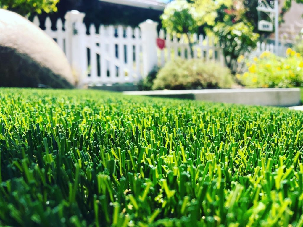 Close-up of artificial grass in front of a California home.